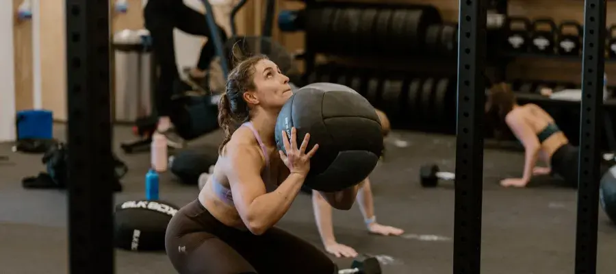Image of person doing wall balls in crossfit gym